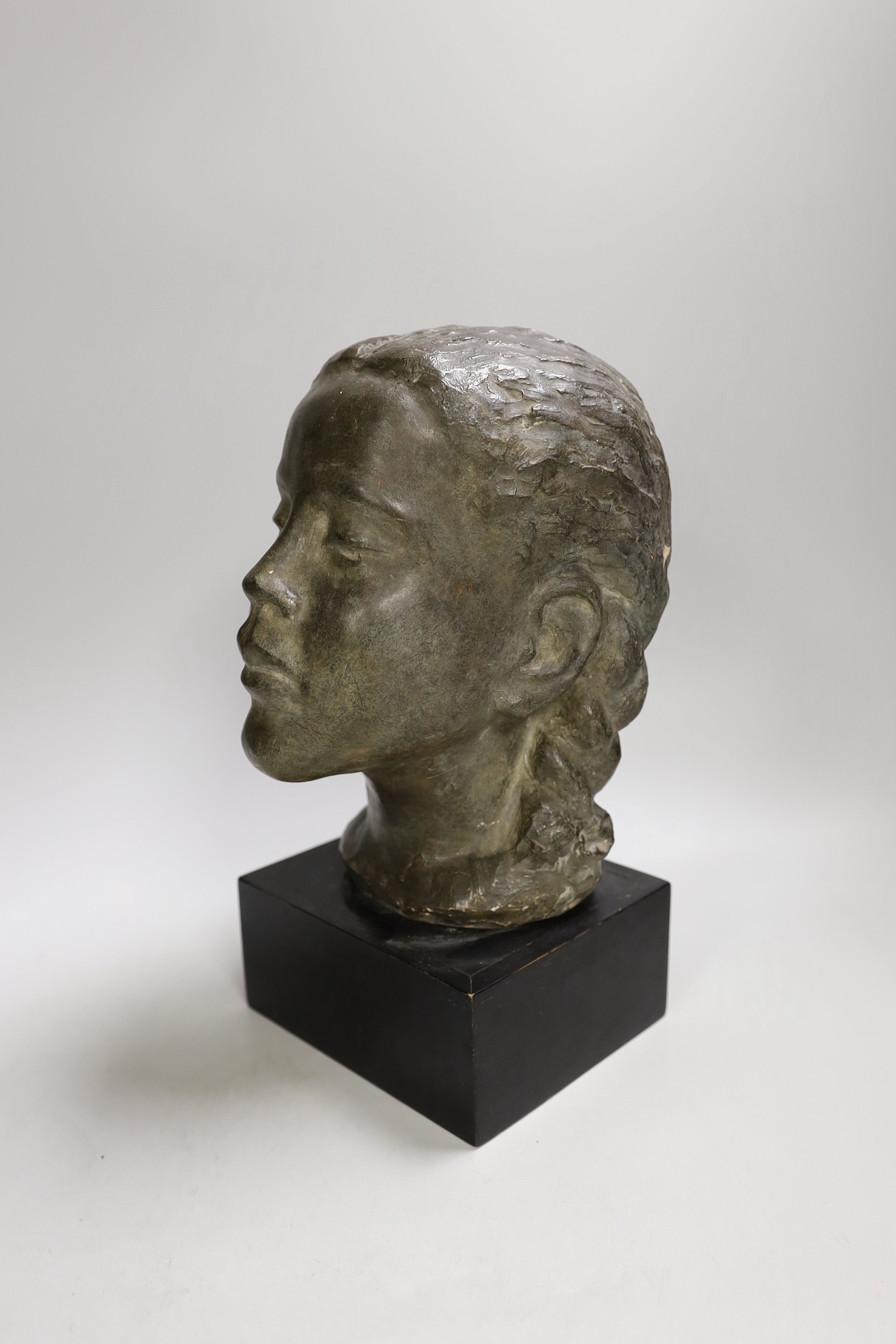 A terracotta bust of a girl on mount. 29cm tall overall